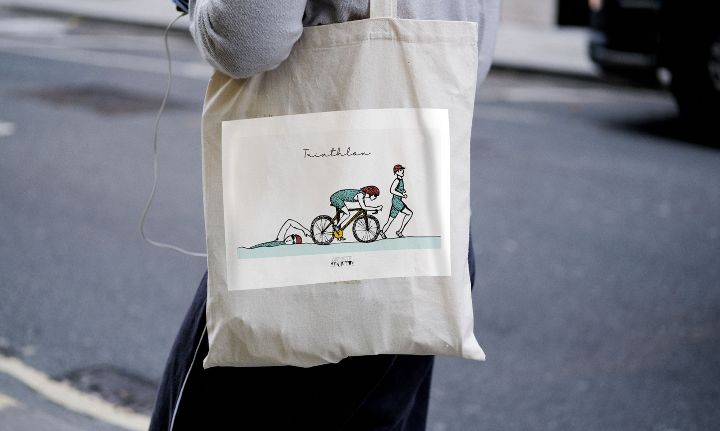 a person holding a bag with a picture of a person on a bike