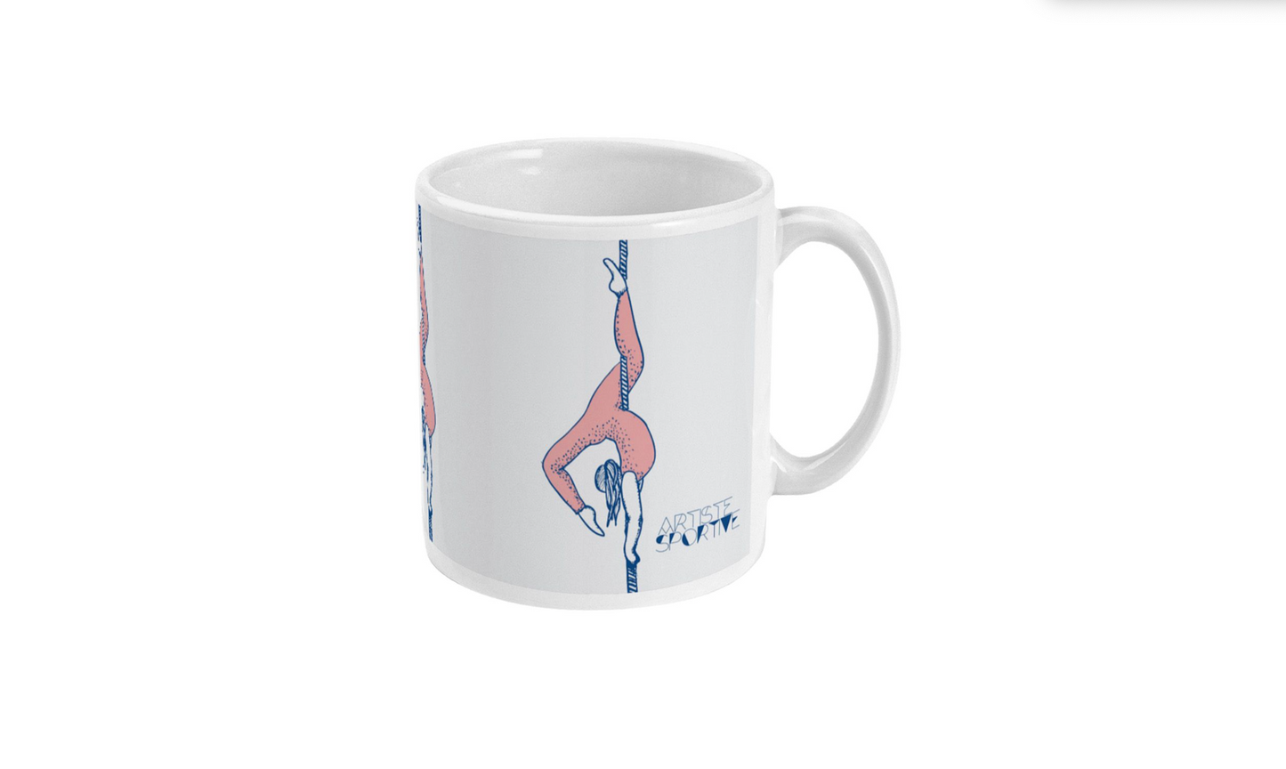 a white coffee mug with a picture of a woman doing a handstand