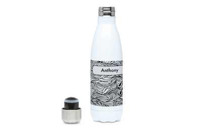 a white bottle with a black and white label next to it
