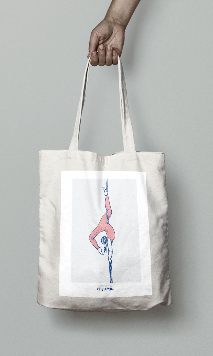 a person holding a bag with a picture of a woman doing yoga