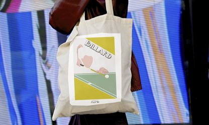 a woman carrying a bag with a picture of a tennis player on it