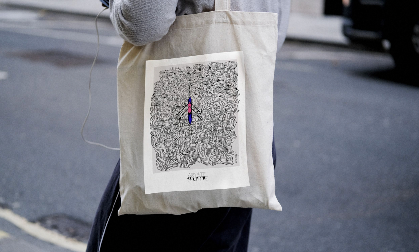 a person holding a bag with a drawing on it