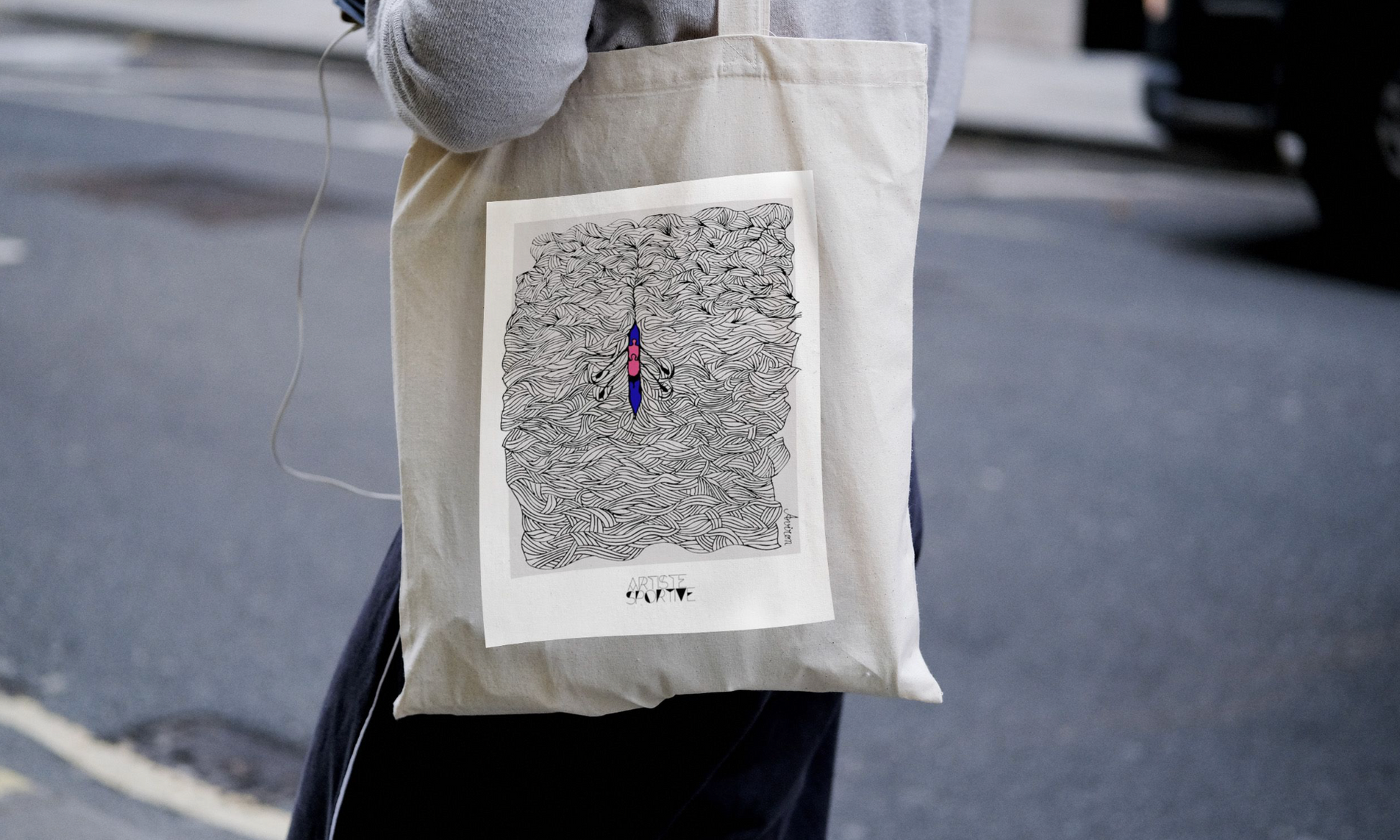 a person holding a bag with a drawing on it