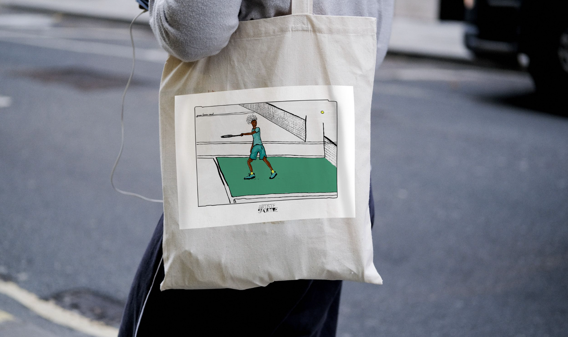 a person holding a bag with a picture of a tennis player on it