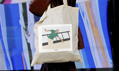 a woman carrying a tote bag with a picture of a woman on it