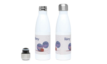 a white bottle with a silver lid next to a bottle with a black cap