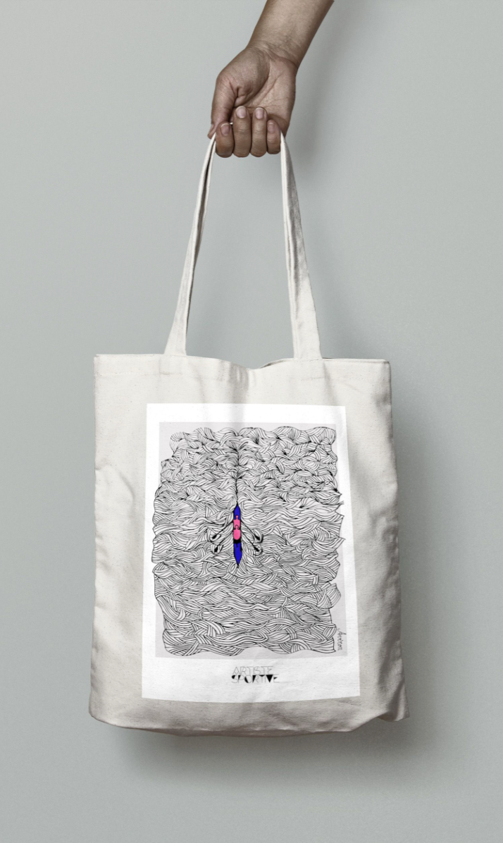 a person holding a bag with a drawing on it
