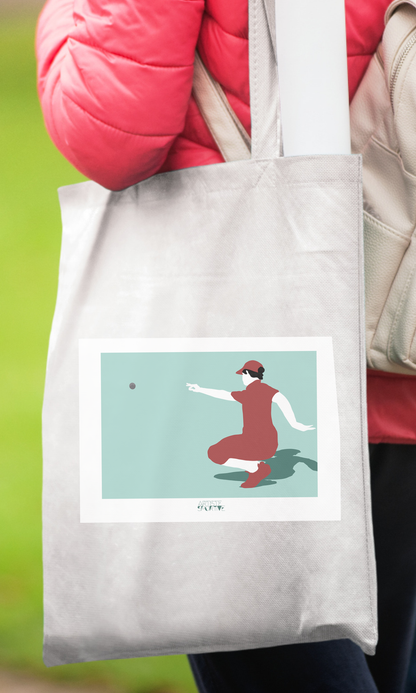 a woman carrying a bag with a picture of a woman throwing a ball