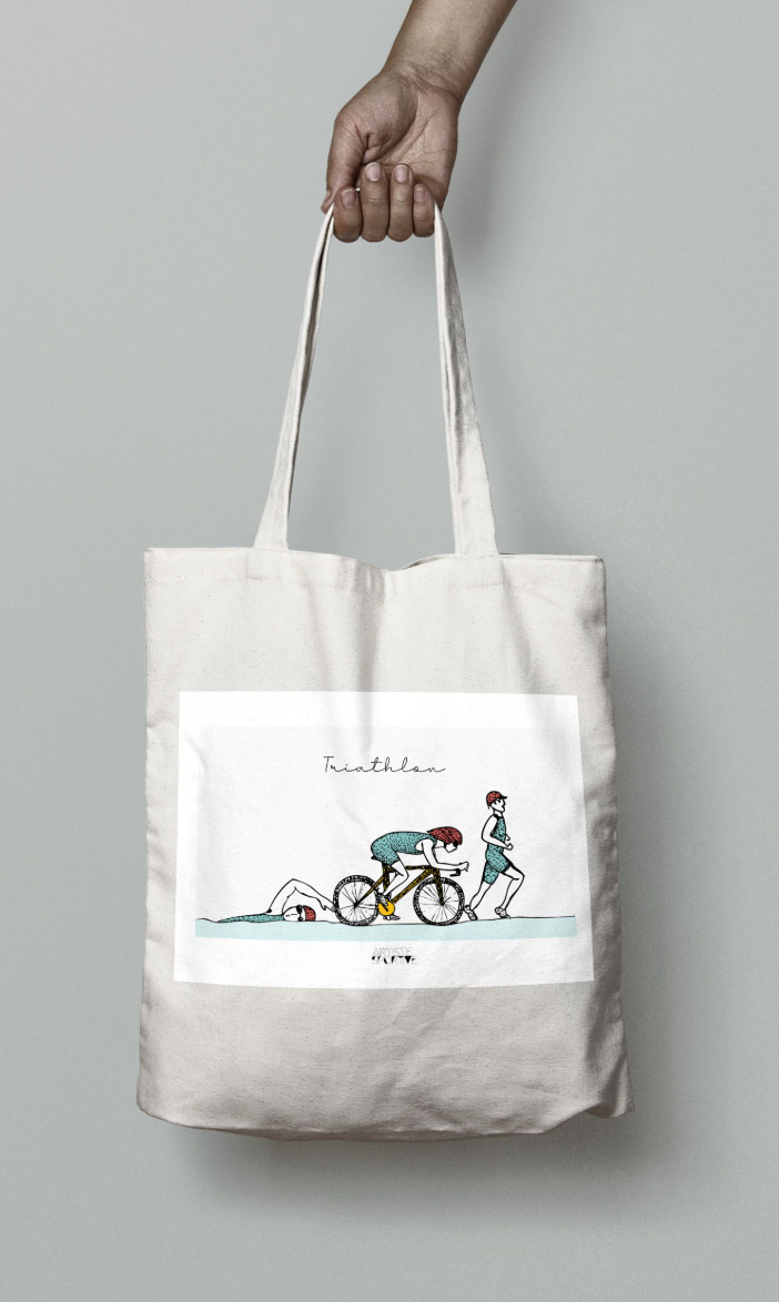 a person holding a bag with a picture of a person on a bike