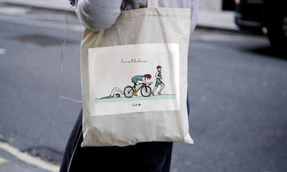 a person holding a bag with a picture of a person on a bike