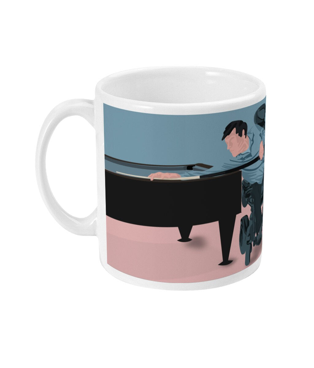 a coffee mug with a picture of a man playing a piano