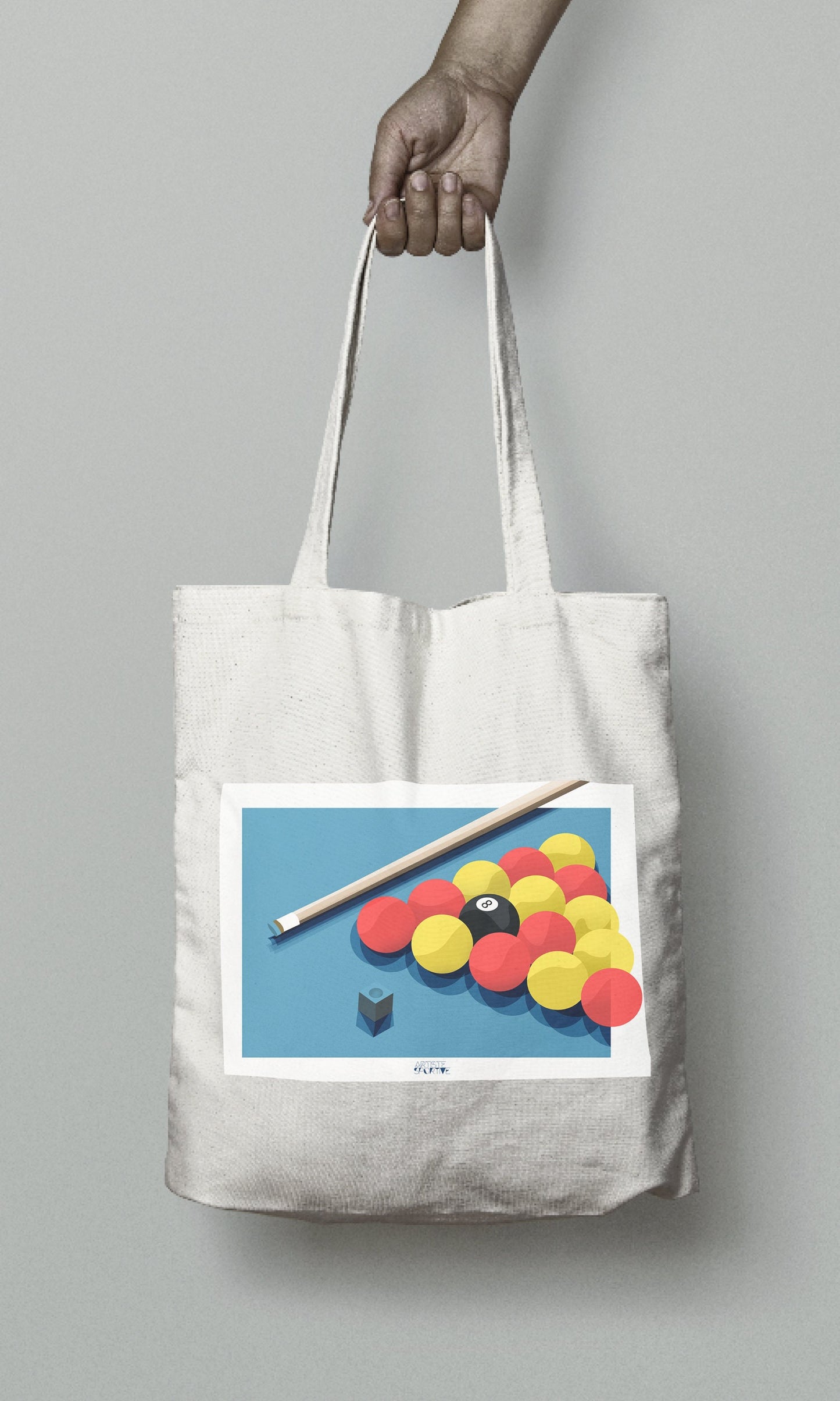 a person holding a tote bag with a picture of a pool ball and cue