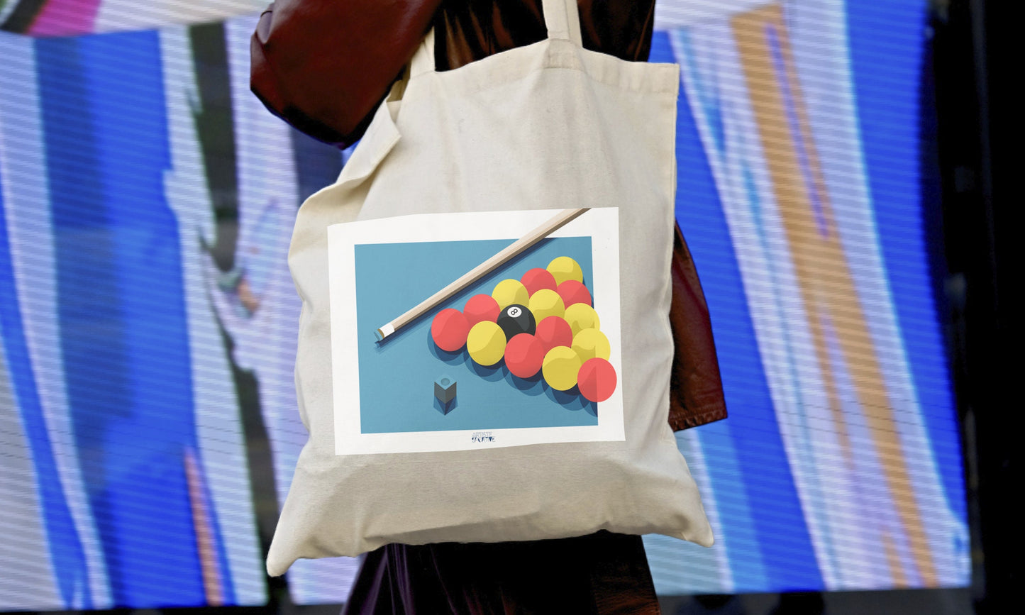 a person holding a bag with a picture of a pool ball on it