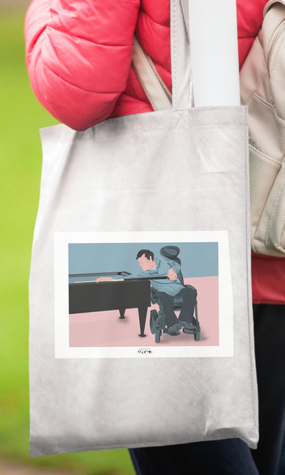 a person holding a tote bag with a picture of a man playing a piano