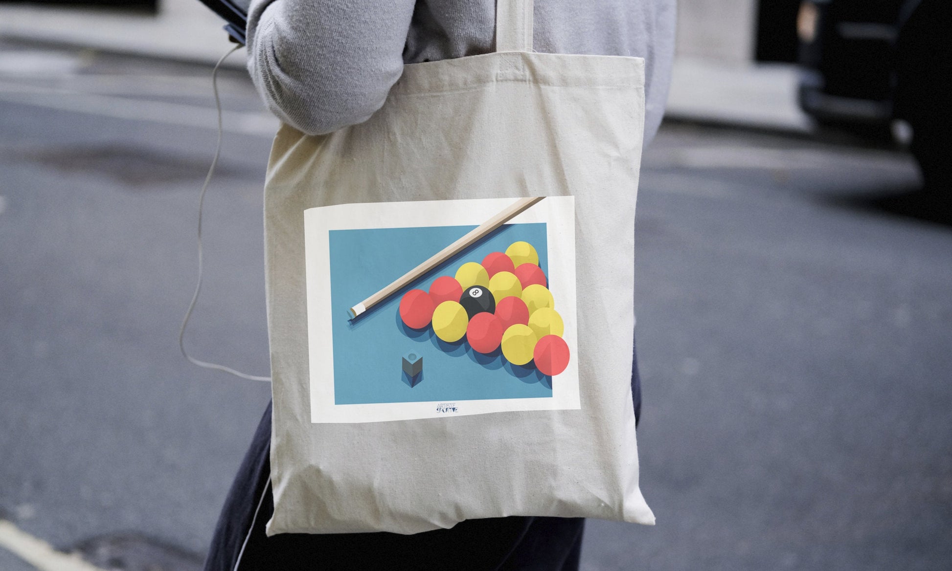 a person carrying a bag with a picture of a pool ball