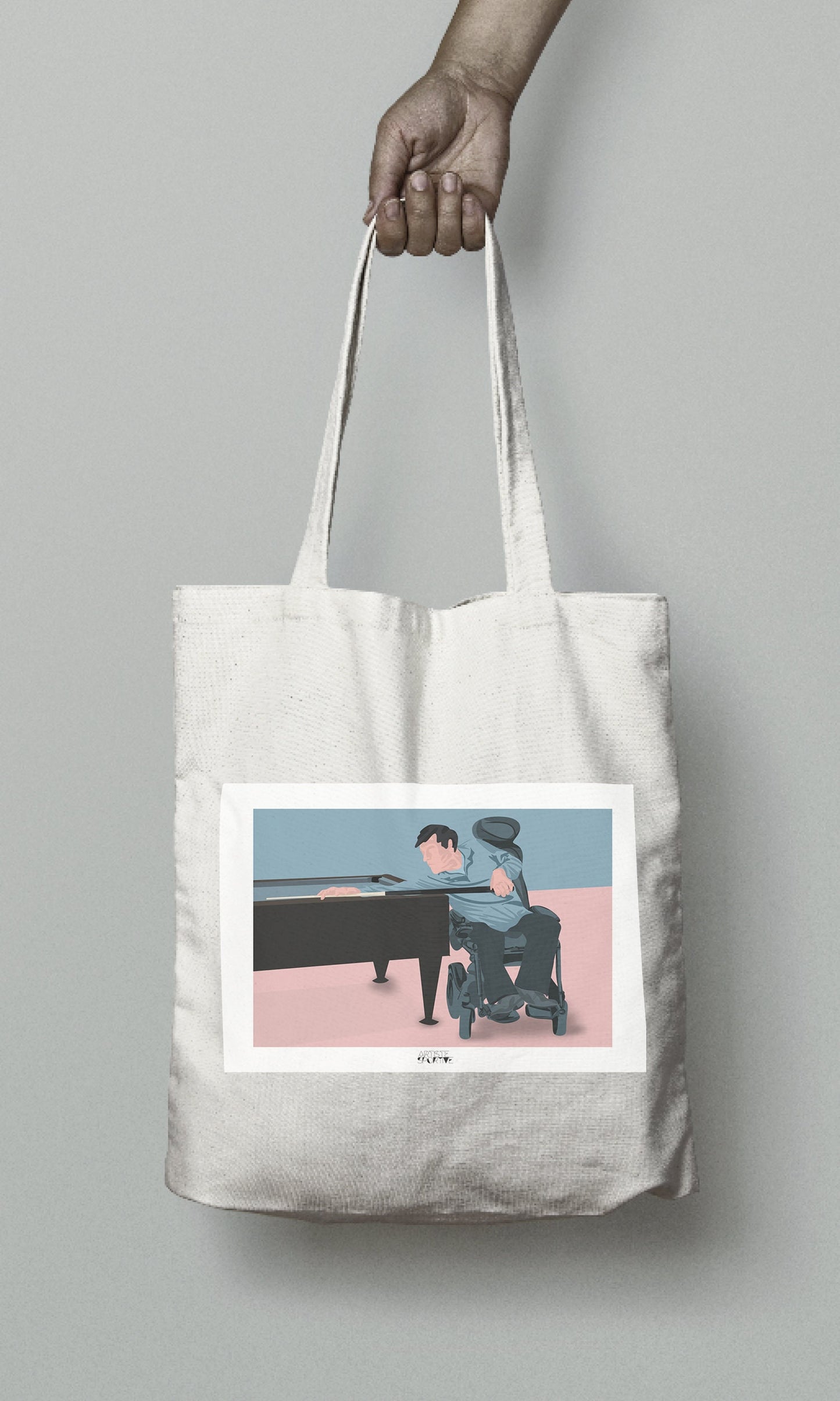 a person holding a tote bag with a picture of a man playing a piano