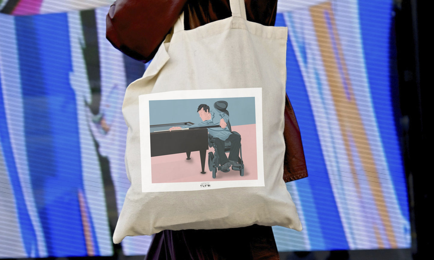 a woman carrying a tote bag with a picture of a woman playing a piano